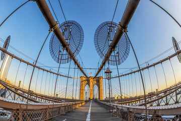 Large angle view of Brooklyn bridge in afternoon light with tourists that crossing. New York, USA