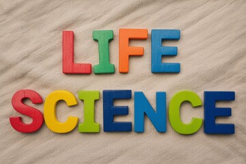 Colorful Wooden Blocks Spell Life Science" on Textured Wood Background"