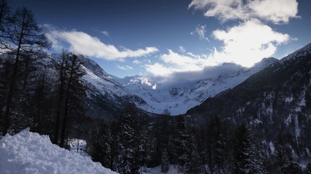 Timelapse of clouds moving over snowy alpine landscape in the Engadin, Switzerland