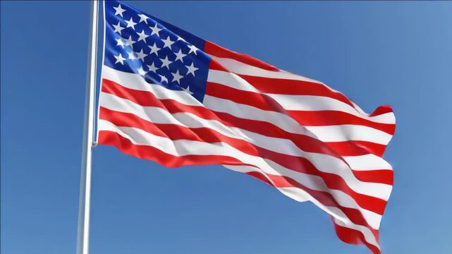 A waving American flag set against a clear blue sky, symbolizing national pride and patriotism.