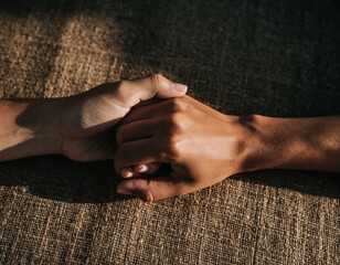 Close up of hands holding each other for support