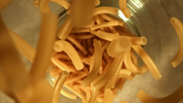 Super slow motion dry maccheroni pasta . Filmed on a high-speed camera at 1000 fps. High quality FullHD footage