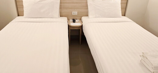 Comfortable hotel room. Bed in the hotel room is covered with white sheets, looks clean, the walls...
