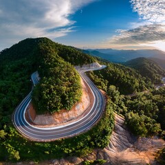 Aerial View of Scenic Winding Mountain Road Through Dense Green Forest, Curved Highway Landscape in Summer Nature, Drone Photography of Serpentine Road in Hills, Travel and Transportation Concept