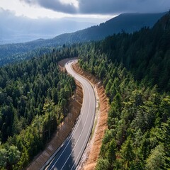 Aerial View of Scenic Winding Mountain Road Through Dense Green Forest, Curved Highway Landscape in Summer Nature, Drone Photography of Serpentine Road in Hills, Travel and Transportation Concept