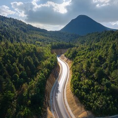 Aerial View of Scenic Winding Mountain Road Through Dense Green Forest, Curved Highway Landscape in Summer Nature, Drone Photography of Serpentine Road in Hills, Travel and Transportation Concept