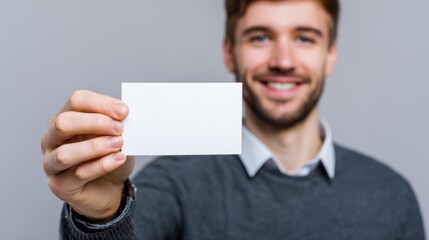 Young man with a blank card for your message