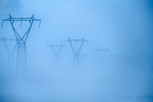 View of electricity poles in winter