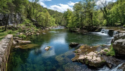 Serene river flowing through lush green valley.  Crystal-clear water reflects the sky and trees.  Rocks and foliage surround the tranquil scene