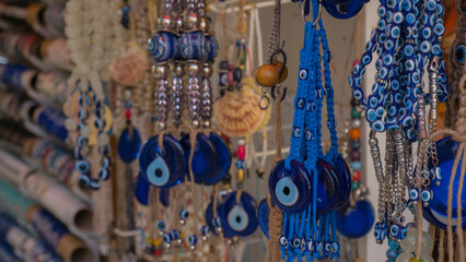 Colorful display of traditional Turkish nazar amulets and handmade jewelry in a vibrant market stall.