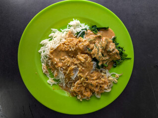 mixed vegetables served with white rice, accompanied by peanut sauce