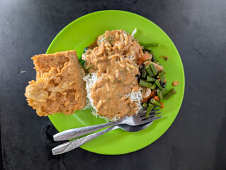 White Rice with Shredded Chicken Curry Gravy and Long Bean Stir-Fry on Green Plate