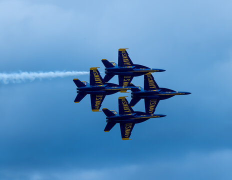Naval Airshow, F-18 Super Hornet jets flying in formation on beautiful summer day high in the clouds - Powered by Adobe