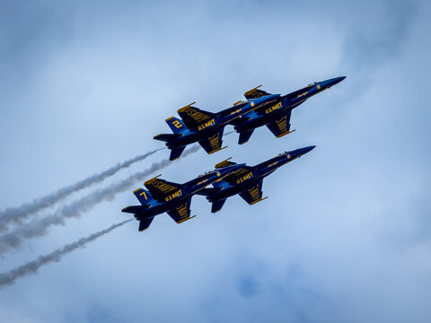 Naval Airshow, F-18 Super Hornet jets flying in formation on beautiful summer day high in the clouds - Powered by Adobe