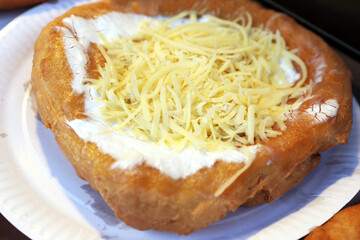 Freshly baked traditional hungarian langos langosch langosh with sour cream and cheese for sale