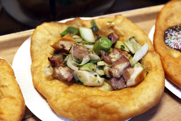 Freshly baked traditional hungarian langos langosch langosh with onion bacon for sale