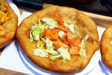 Freshly baked traditional hungarian langos langosch langosh with salmon and salad for sale