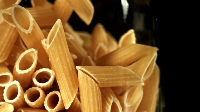 Super slow motion dry penne pasta . Filmed on a high-speed camera at 1000 fps. High quality FullHD footage