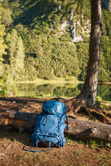 Hiking backpack in forest at Austrian Alp mountains. Travel and trekking outdoor equipment