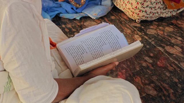 Man intently reading a holy book like the gita or vedas