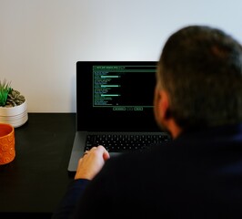 Middle Aged Systems Administrator Engineer Restoring Backups After Ransomware Hacking Attempt - Cybersecurity and Data Protection Concept