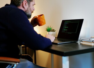 Middle Aged Systems Administrator Engineer Restoring Backups After Ransomware Hacking Attempt - Cybersecurity and Data Protection Concept