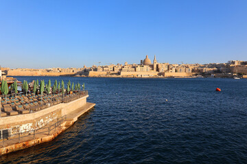 Fototapeta premium Sliema bay and the Dome of the Basilica of Our Lady of Mount Carmel and Valletta, il-Belt Valletta is the capital city of Malta and one of its 68 council areas.