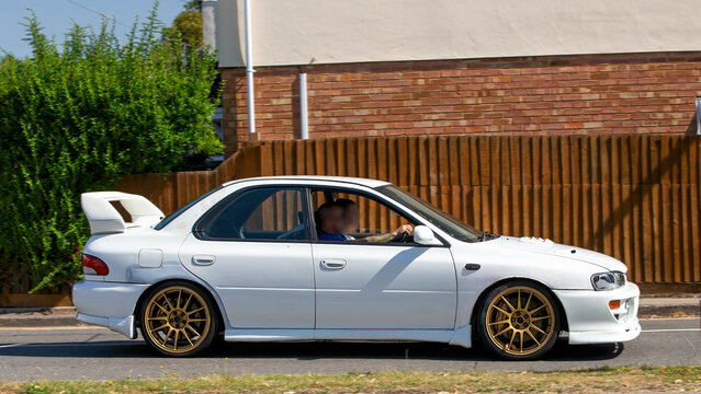 Bletchley,Bucks,UK - Aug 25th 2025: 1996 white Subaru Impreza wrx classic car driving on a British road