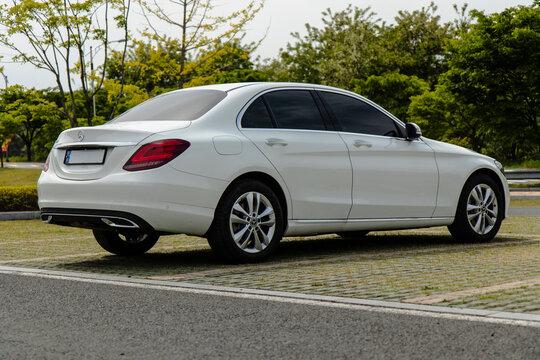 May 6, 2021, Seoul, South Korea - White Mercedes-Benz C200 sedan parked on a grass paver lot