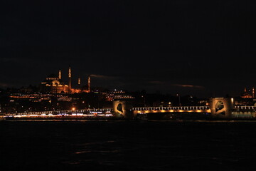 Illuminated S&uuml;leymaniye Mosque and bridge lights in Istanbul at night