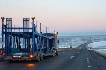 Naklejka premium Car transporter for transporting passenger cars on country roads.