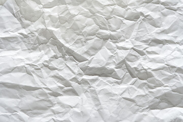 Obraz premium Crumpled white paper texture for backgrounds and artistic designs.