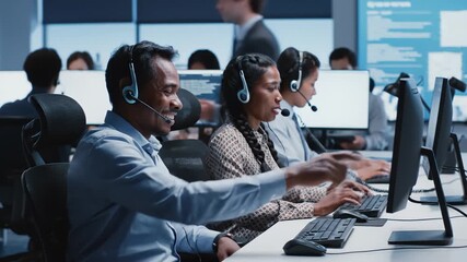 Diverse Call Center Operators Working on Computers at Desks - Powered by Adobe