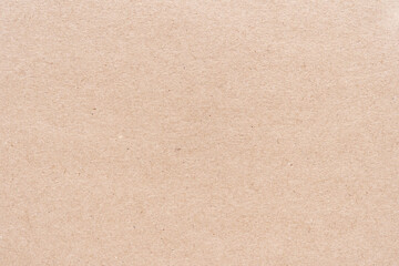 Fototapeta premium Close-up of textured brown cardboard surface with natural patterns and rough texture.