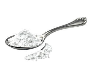 Close-up of a silver spoon holding a pile of fine, white powder, with a small pile spilled