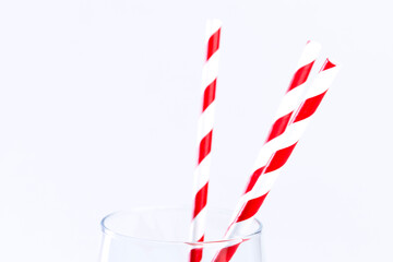 Red and white paper straws in a glass. Close-up