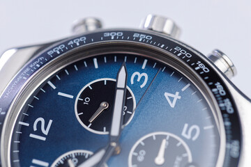 Close up of luxury chronograph watch dial with blue face