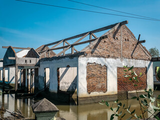a house that was abandoned by its owner and destroyed by tidal flooding