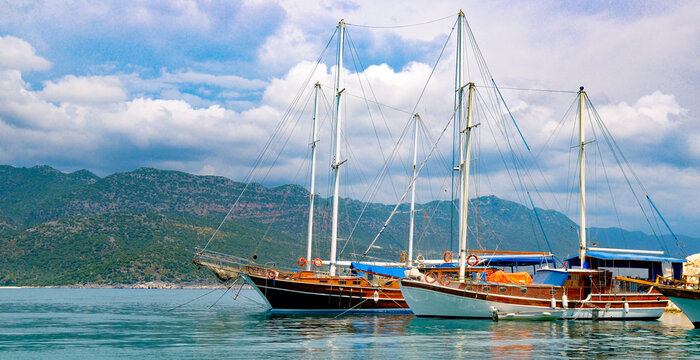 Traditional wooden gulet yachts anchored in a Mediterranean bay