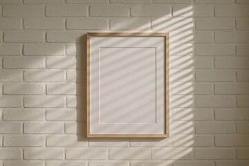 Minimalistic mockup of empty frame on white brick wall with soft natural light.