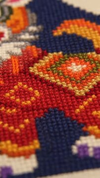 Detailed needlepoint craftwork with an animal motif