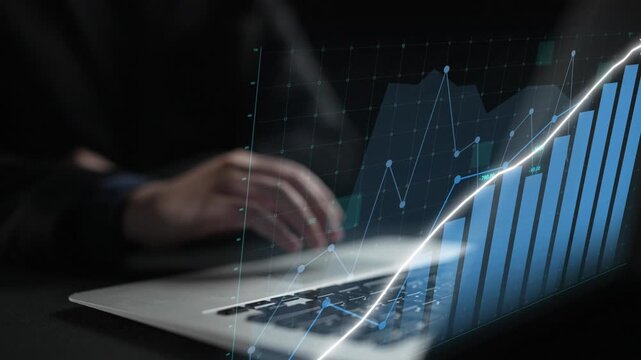 Hands interacting with a laptop on a dark surface, combined with a dynamic digital graph overlay, illustrating financial growth and analysis in a modern workspace. Copula