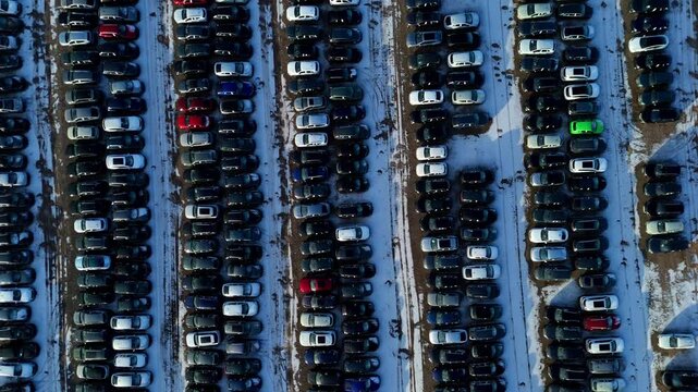 Aerial view of rows of cars in the BCA car storage facility, contrasting against the snowy landscape, Geddington Road, Corby, United Kingdom.