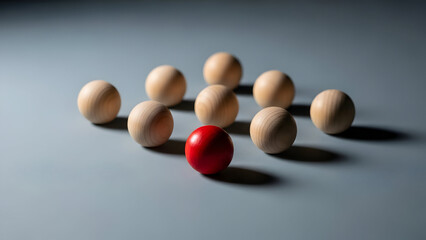 Elevate your brand with this striking image of wooden spheres, where a single red ball stands out, symbolizing uniqueness and innovation in business ideas.
