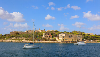 Naklejka premium Valletta Waterfront, is a promenade in Floriana, Malta, mainly featuring three prominent buildings a church, the Pinto Stores or the Pinto Wharf and the Forni Stores