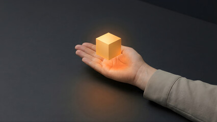 A hand holds a single, glowing cyan holographic cube in a minimalist composition with ample copy space. A concept of focus, core ideas, innovation, and simplicity in technology.