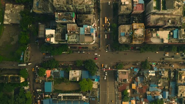 Aerial view of buildings and roads with vehicles, a vibrant tapestry of urban life with contrasting colors, textures, and tones, Howrah, West Bengal, India.