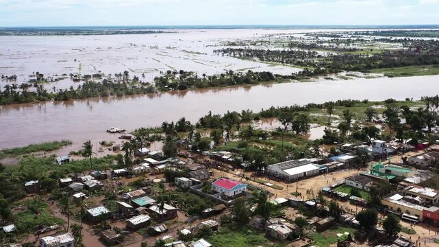Aerial view of a village submerged in murky floodwater, showing the devastation and displacement after heavy rains, Beira, Sofala Province, Mozambique.