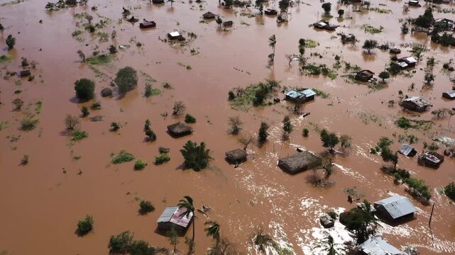 Aerial view of floodwaters surrounding homes, trees, and vegetation, creating a scene of devastation, Beira, Sofala Province, Mozambique.