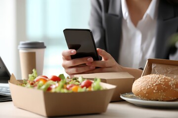 Office worker with lunch and smartphone